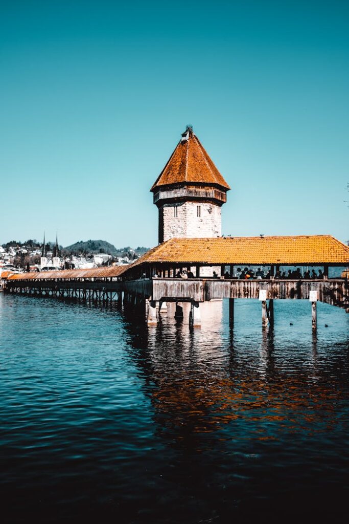 Picturesque view of Chapel Bridge over Reuss River in Lucerne, Switzerland, showcasing its historic architecture.